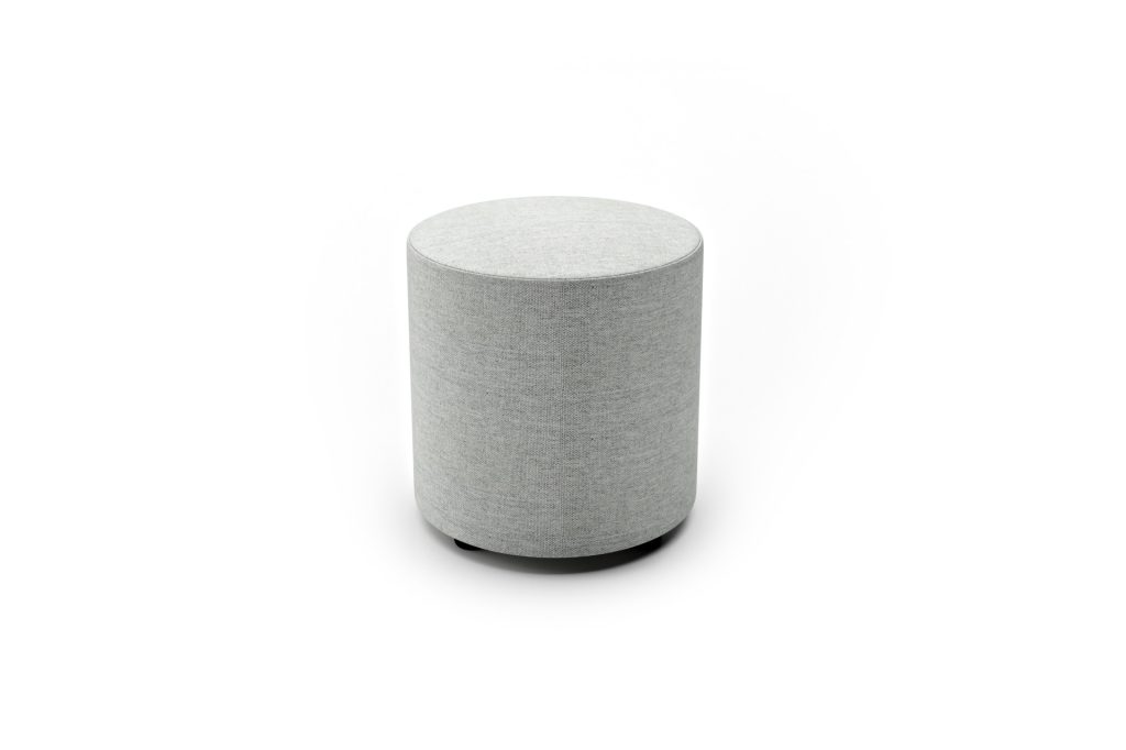 Cylindrical modular breakout seating stool with fabric upholstery, suitable for office, education, and reception spaces.