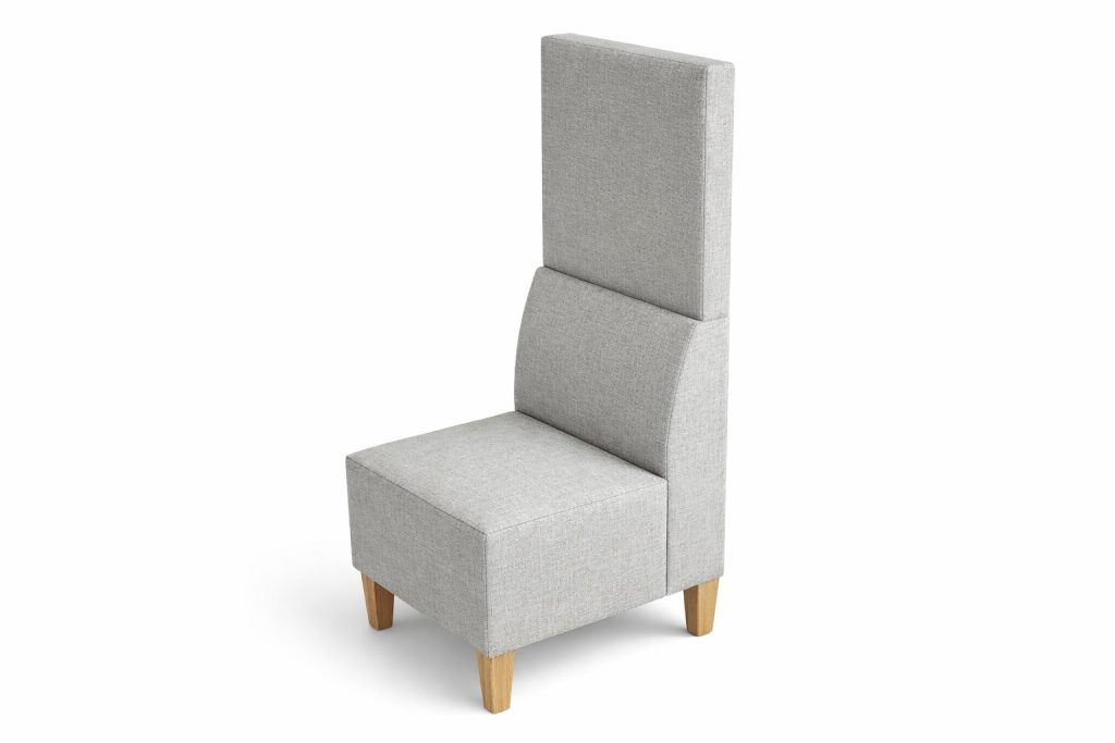 Modular breakout seating with high back, upholstered in light fabric, on wooden legs.